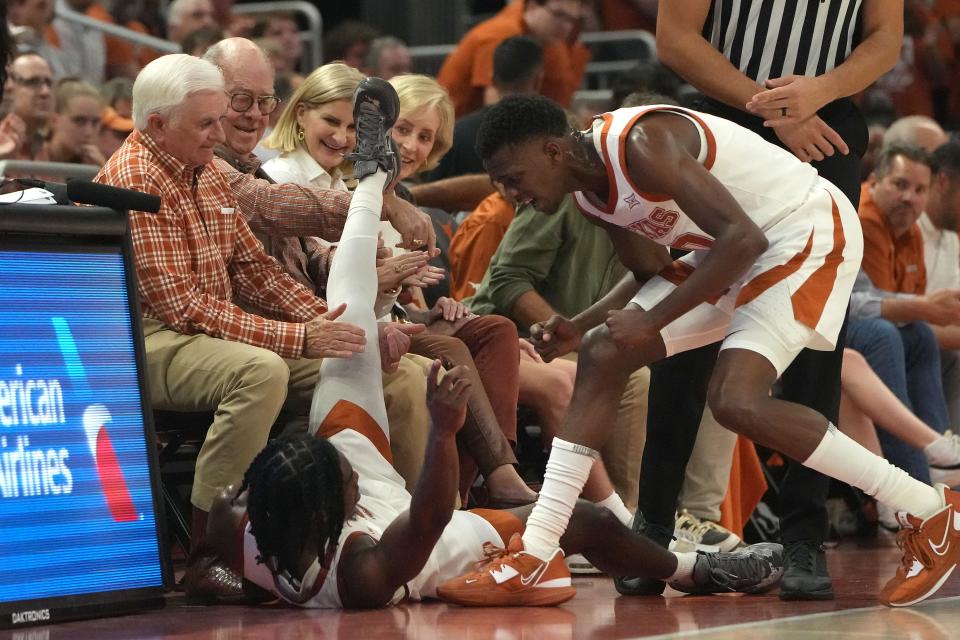 Texas' Marcus Carr lands at the feet of a Texas fan during Monday night's 72-57 win over UTEP. Things are definitely going be more intimate at the new Moody Center compared to the old Erwin Center. Texas averaged 12,398 fans last year in the arena that sat more than 16,000. Moody seats 10,763, though about 600 more packed into Monday's game.