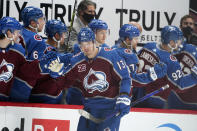 Colorado Avalanche right wing Valeri Nichushkin, front, is congratulated as he passes the team box after scoring a goal against the San Jose Sharks during the second period of an NHL hockey game Tuesday, Jan. 26, 2021, in Denver. (AP Photo/David Zalubowski)