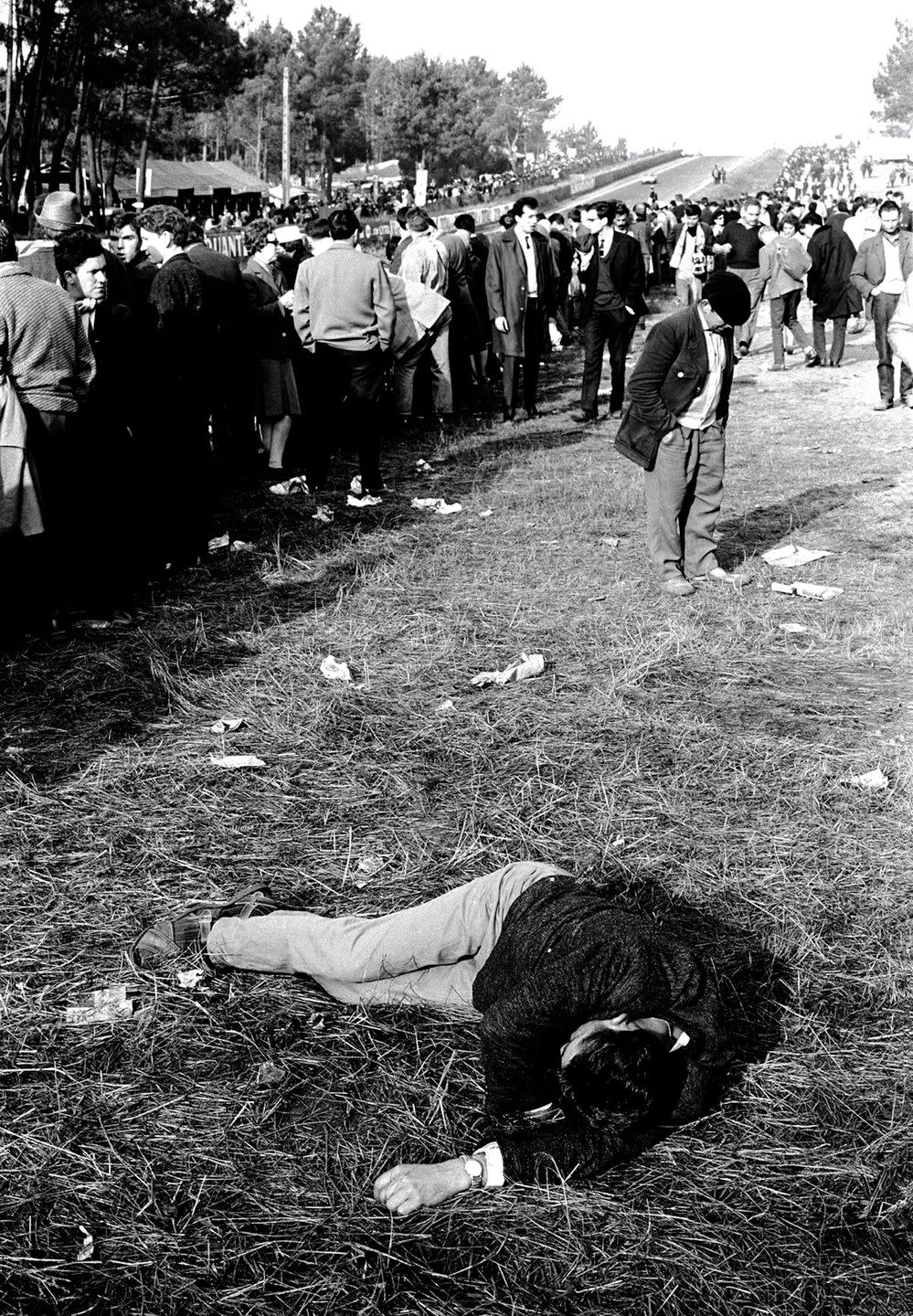 man napping in the grass at le mans