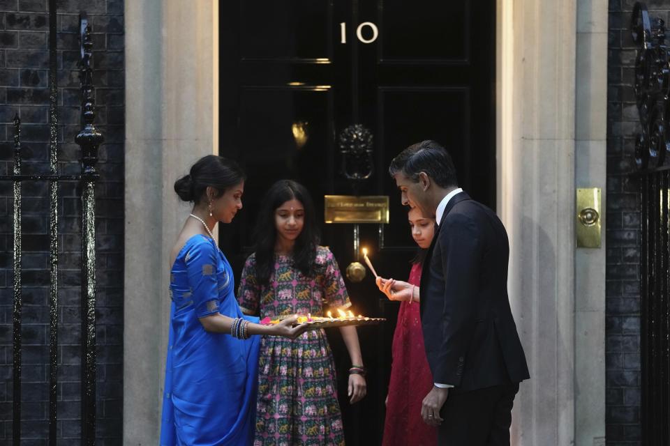FILE - Britain's Prime Minister Rishi Sunak, right, lights the candles with his wife Akshata Murty and daughters to celebrate Diwali at 10 Downing Street in London, Sunday, Nov. 12, 2023. Diwali is known as the Festival of Lights. (AP Photo/Kin Cheung, File)