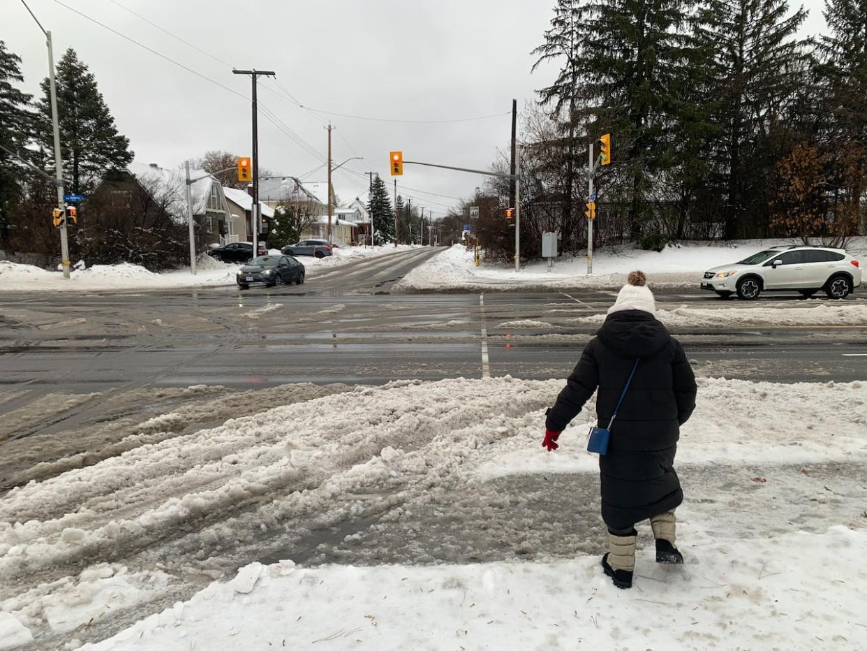 A person walks through slush Dec. 23, 2022 after snow turned into rain during a winter storm. The forecast is similar today and tomorrow. (André Dalencour/Radio-Canada - image credit)