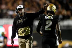 BOULDER, CO - SEPTEMBER 16: Head coach Deion Sanders of the Colorado Buffaloes celebrates with quarterback Shedeur Sanders #2 after a fourth quarter touchdown against the Colorado State Rams at Folsom Field on September 16, 2023 in Boulder, Colorado. (Photo by Dustin Bradford/Getty Images)