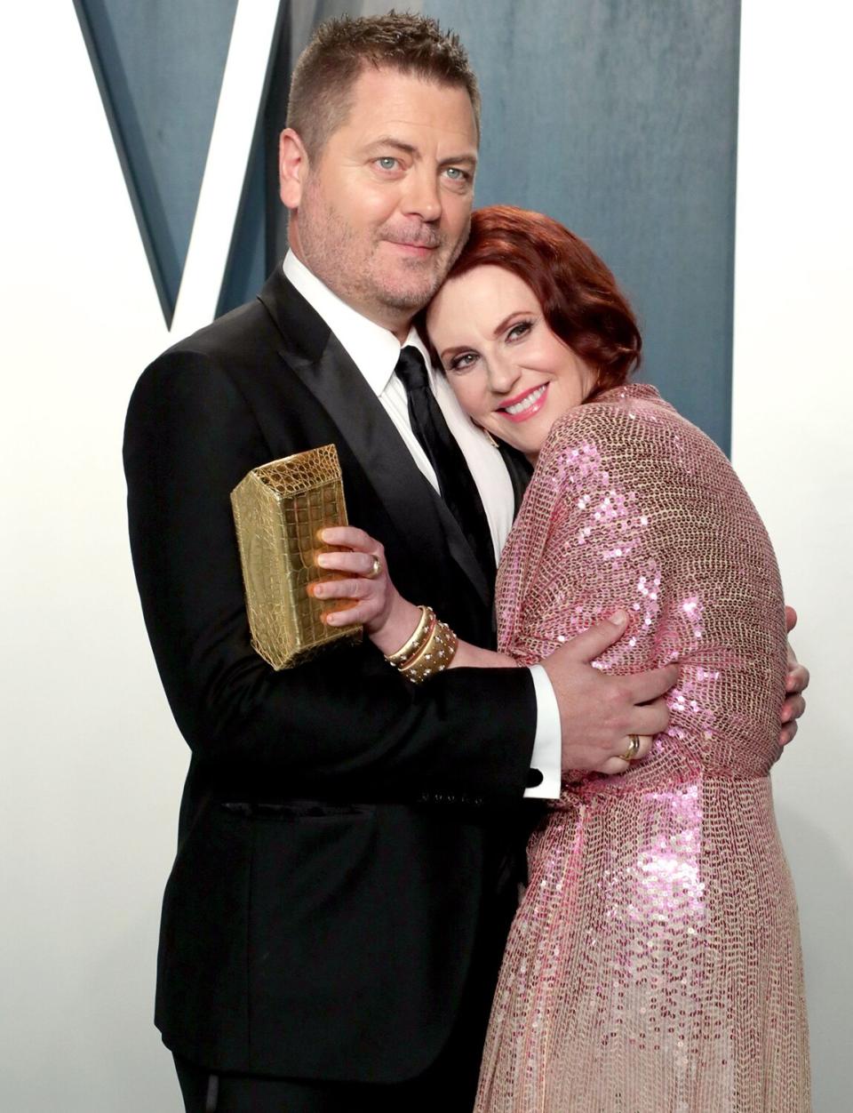 Nick Offerman and Megan Mullally share a sweet hug outside of the 2020 Vanity Fair Oscar Party. 
