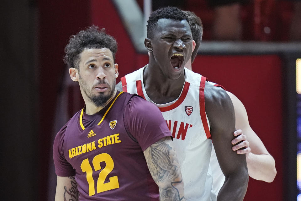 Utah center Keba Keita, right reacts after scoring, next to Arizona State guard Jose Perez (12) during the first half of an NCAA college basketball game Saturday, Feb. 10, 2024, in Salt Lake City. (AP Photo/Rick Bowmer)