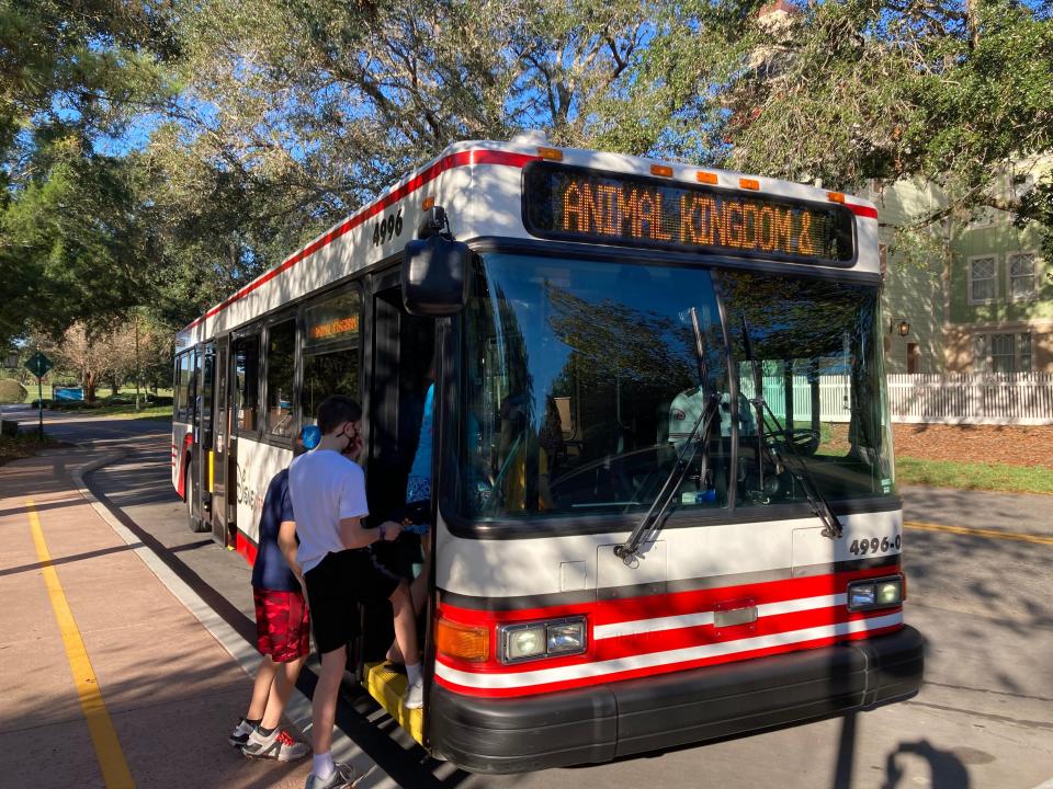 people getting on a disney bus marked animal kingdom at saratoga springs resort