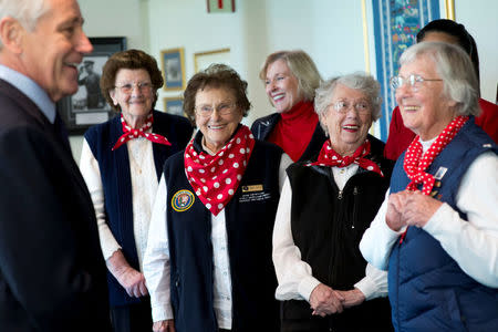 Secretary of Defense Chuck Hagel (L) laughs with, (L-R) Marian Wynn, Agnes Moore, Marian Sousa and Phyllis Gould, women who worked during World War II, at the Pentagon, in Arlington, Virginia, U.S., March 31, 2014. Erin A. Kirk-Cuomo/DOD/Handout via REUTERS