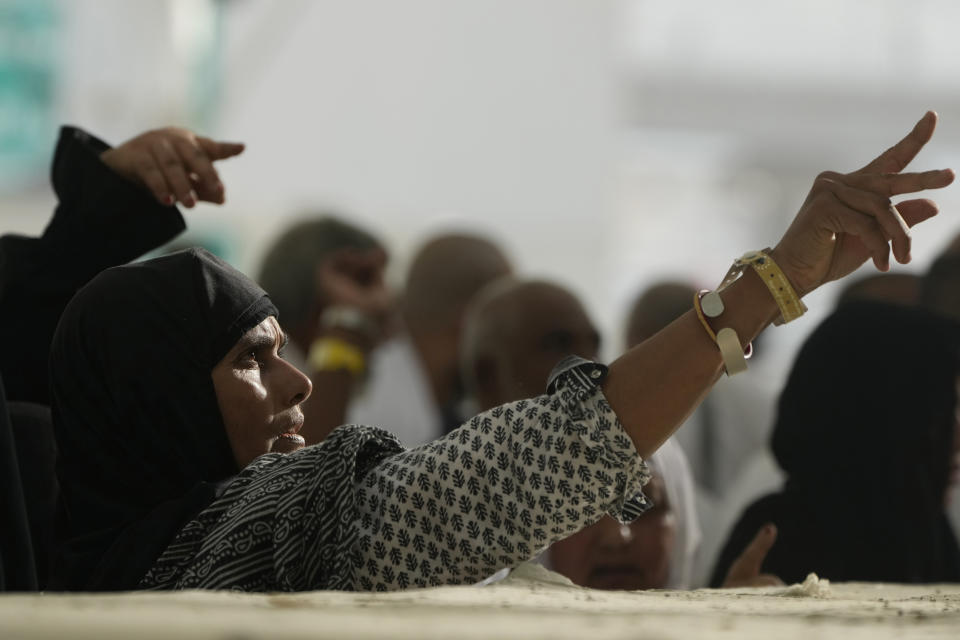 Pilgrims cast stones at a pillar in the symbolic stoning of the devil, the last rite of the annual Hajj pilgrimage, in Mina near the holly city of Mecca, Saudi Arabia, Wednesday, June 28, 2023. (AP Photo/Amr Nabil)