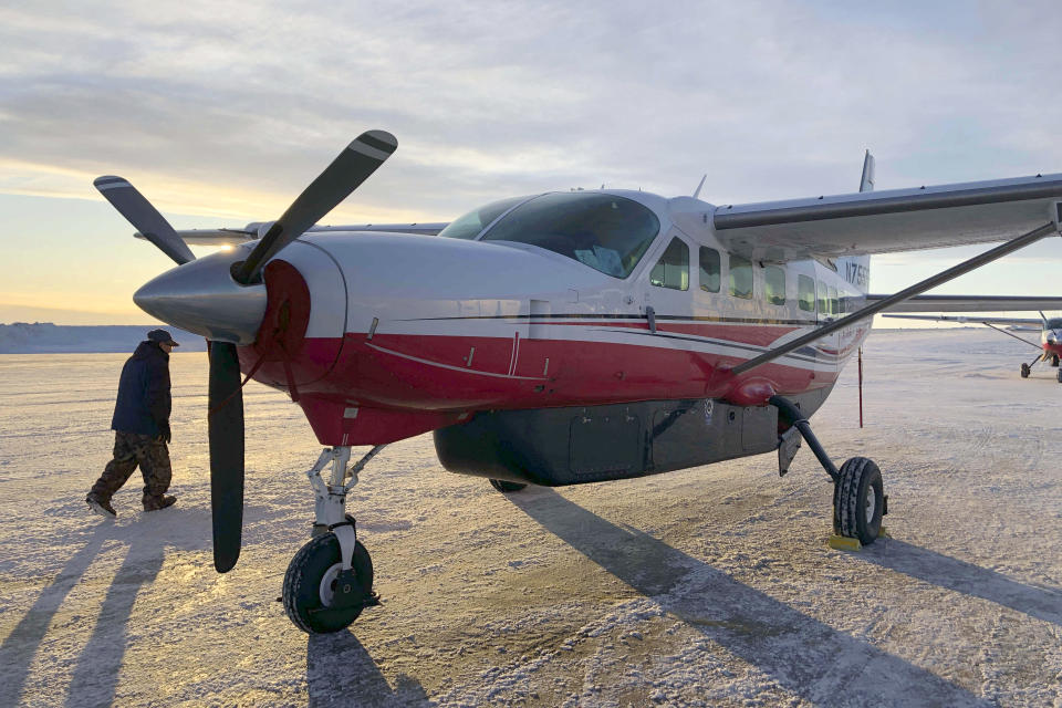 FILE - This Jan. 18, 2020, photo shows people preparing to get on a Ravn Connect airplane at the airport in Bethel, Alaska, for a flight to Toksook Bay. The largest rural airline in Alaska has declared bankruptcy and laid off more than a thousand workers but wants $250,000 in bonuses to be awarded to its chief executive and other employees. Alaska Public Radio reported that RavnAir Group filed the request Tuesday, Aug. 11, 2020 in Delaware bankruptcy court. (AP Photo/Mark Thiessen, File)