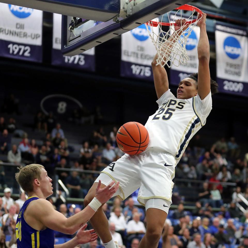 Akron Zips forward Enrique Freeman dunks the ball over South Dakota State guard Charlie Easley during the second half, Monday, Nov. 7, 2022.
