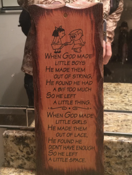 Plaque in a bathroom with a poem about God making little boys and girls, detailing they were made with string and lace respectively, balanced with a touch of humor