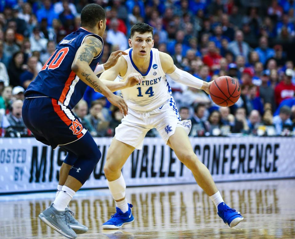 Kentucky Wildcats guard Tyler Herro (14) dribbles the ball against Auburn Tigers guard Samir Doughty (10) during the 2019 NCAA Tournament on March 31, 2019.