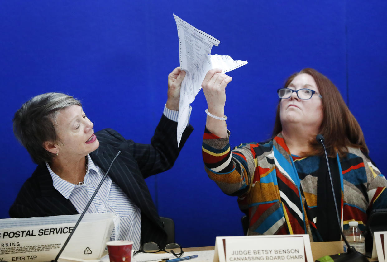 Two members of the Broward County Canvassing Board show political lawyers a damaged ballot that will need to be duplicated and then recounted, Nov. 14, 2018, in Lauderhill, Fla. (Photo: Wilfredo Lee/AP)