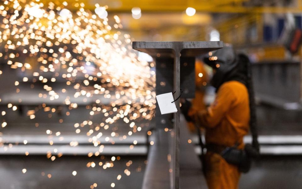 n employee grinds smooth a section of fabricated steel beam at Severfield Plc steel fabricators in Dalton, near Thirsk, UK, on Sunday, Aug. 22, 2022 - Chris Ratcliffe/ Bloomberg