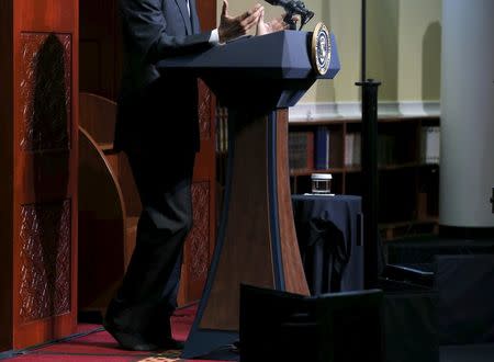 U.S. President Barack Obama goes without shoes, out of deference, as he delivers remarks at the Islamic Society of Baltimore mosque in Catonsville, Maryland February 3, 2016. REUTERS/Jonathan Ernst