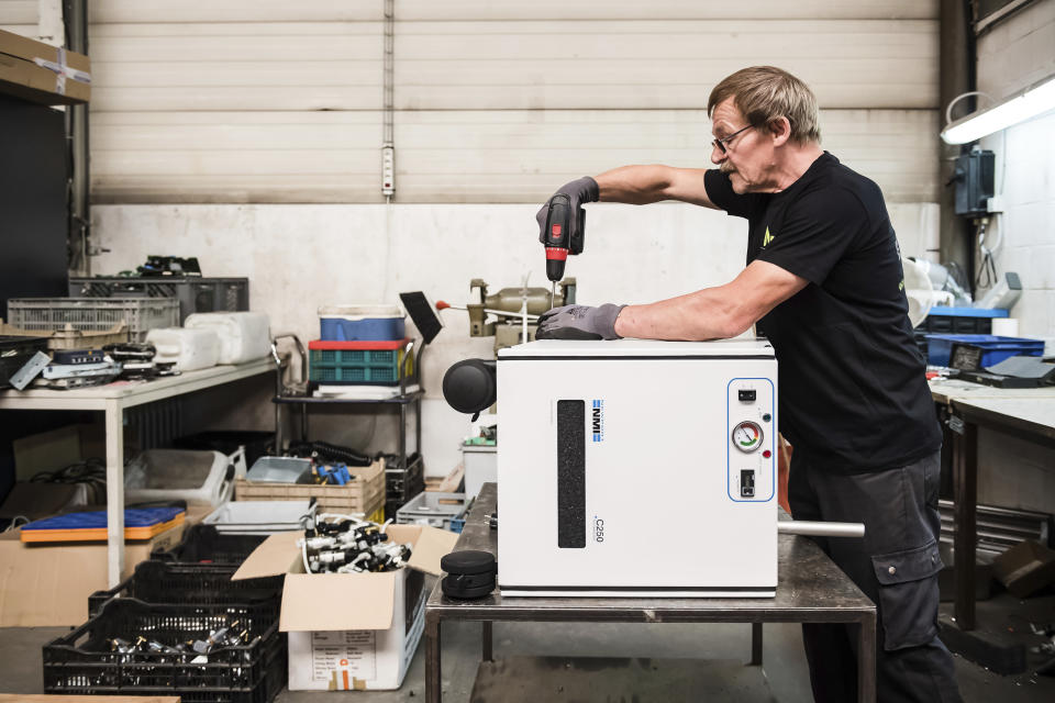 In this photo taken on July 13, 2018, a worker takes apart components of electronic element at the Out Of Use company warehouse in Beringen, Belgium. European Union nations are expected to produce more than 12 million tons of electronic waste per year by 2020, making the Out Of Use company at the front of an expanding market, recuperating raw materials from electronic waste. (AP Photo/Geert Vanden Wijngaert)