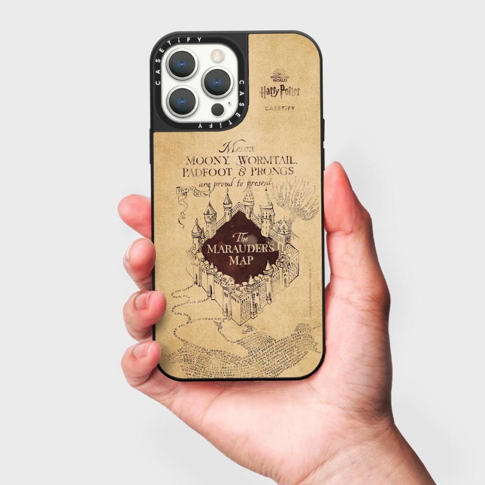 A hand holds up a Marauders Map Lenticular iPhone Case 