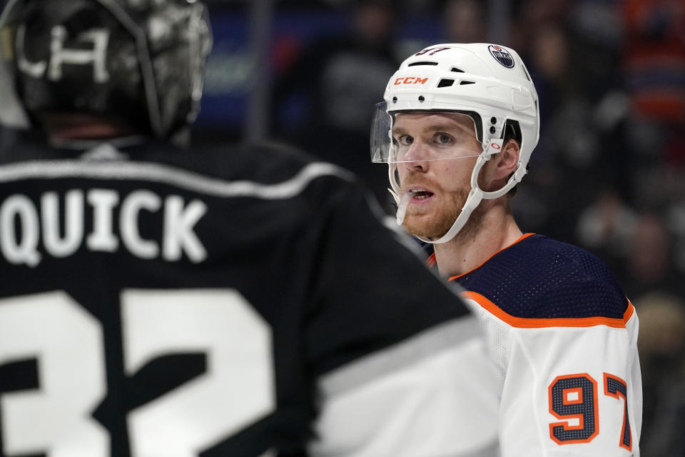 Edmonton Oilers center Connor McDavid, right, looks at Los Angeles Kings goaltender Jonathan Quick during the third period in Game 4 of an NHL hockey Stanley Cup first-round playoff series Sunday, May 8, 2022, in Los Angeles. (AP Photo/Mark J. Terrill)