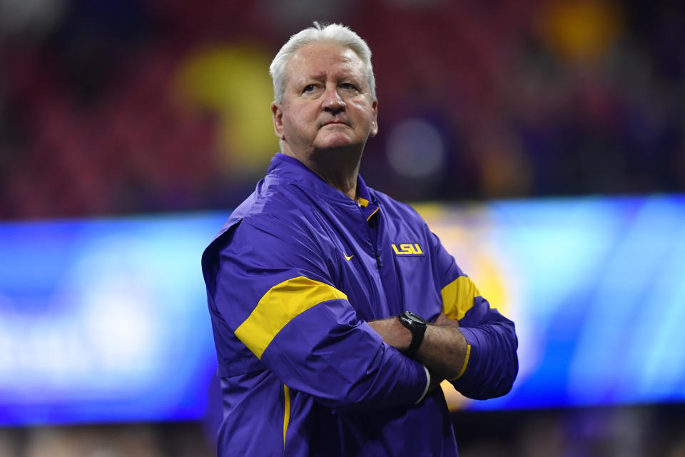 LSU Offensive Coordinator Steve Ensminger watches teams warm up before the first half of the Peach Bowl NCAA semifinal college football playoff game between LSU and Oklahoma, Saturday, Dec. 28, 2019, in Atlanta. Ensminger's daughter-in-law, Carley McCord, died in a plane crash Saturday in Louisiana on the way to the game. (AP Photo/John Amis)