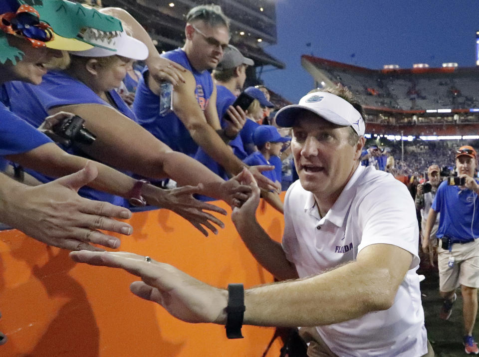 Florida head coach Dan Mullen celebrates with fans as he leaves the field after defeating LSU in an NCAA college football game, Saturday, Oct. 6, 2018, in Gainesville, Fla. (AP Photo/John Raoux)