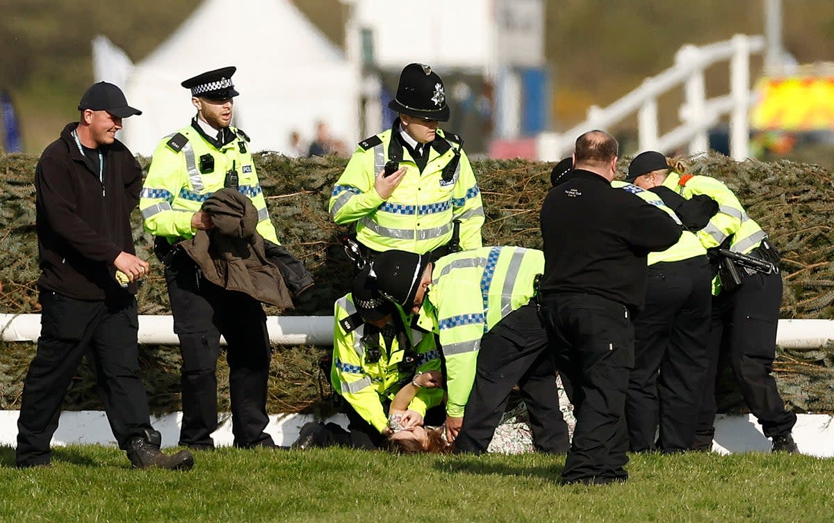 Police contain protestors on the Aintree racecourse (REUTERS)