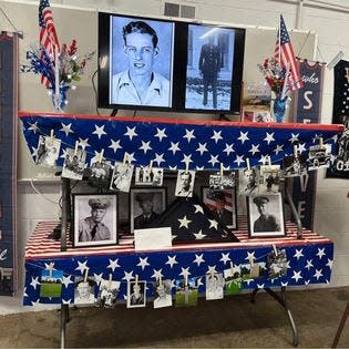 Photos of George M. Gillilan are on display at a Veterans Day observance in Chester, Ohio. Gillilan was killed near the end of World War II. His medals, including a Purple Heart, were purchased and returned after a Dutch filmmaker had found them on the internet.
