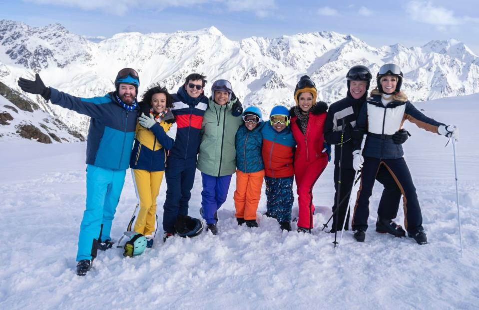 the cast of your christmas or mine 2 posing for a picture on a snow covered mountain