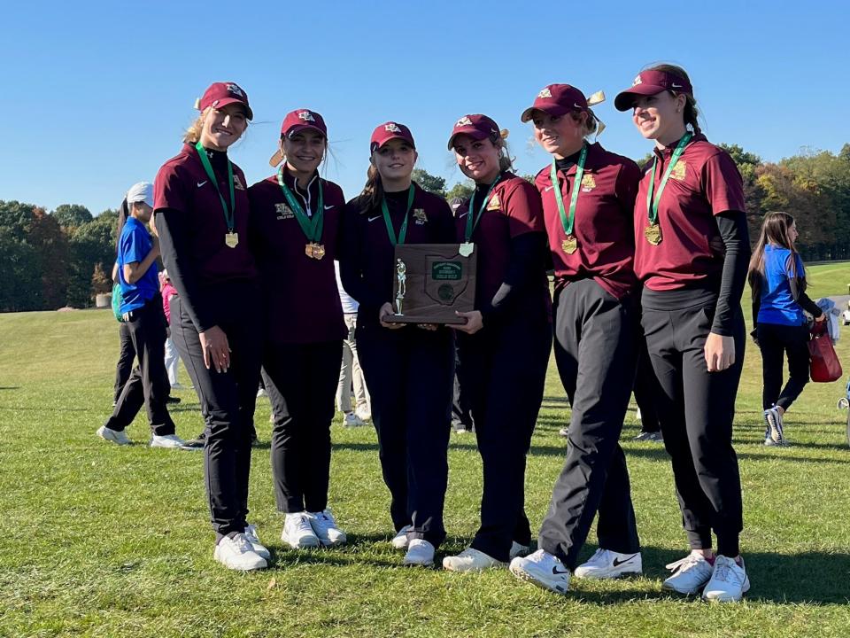 The New Albany girls golf team holds the first-place trophy after winning its sixth consecutive Division I district championship Wednesday at The Links at Echo Springs. The Eagles edged runner-up Dublin Jerome by two shots, 297-299.