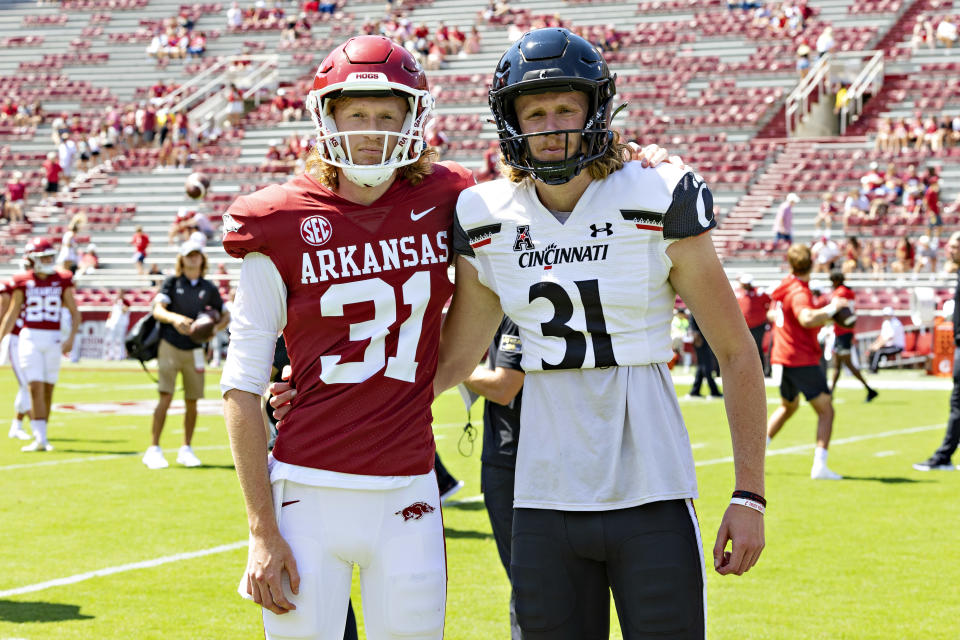 FAYETTEVILLE, ARKANSAS – SEPTEMBER 03: Brothers Mason Fletcher #31 of the Cincinnati Bearcats and Max Fletcher #31 of the Arkansas Razorbacks pose for the camera before a game at Donald W. Reynolds Razorback Stadium on September 03, 2022 in Fayetteville, Arkansas. (Photo by Wesley Hitt/Getty Images)