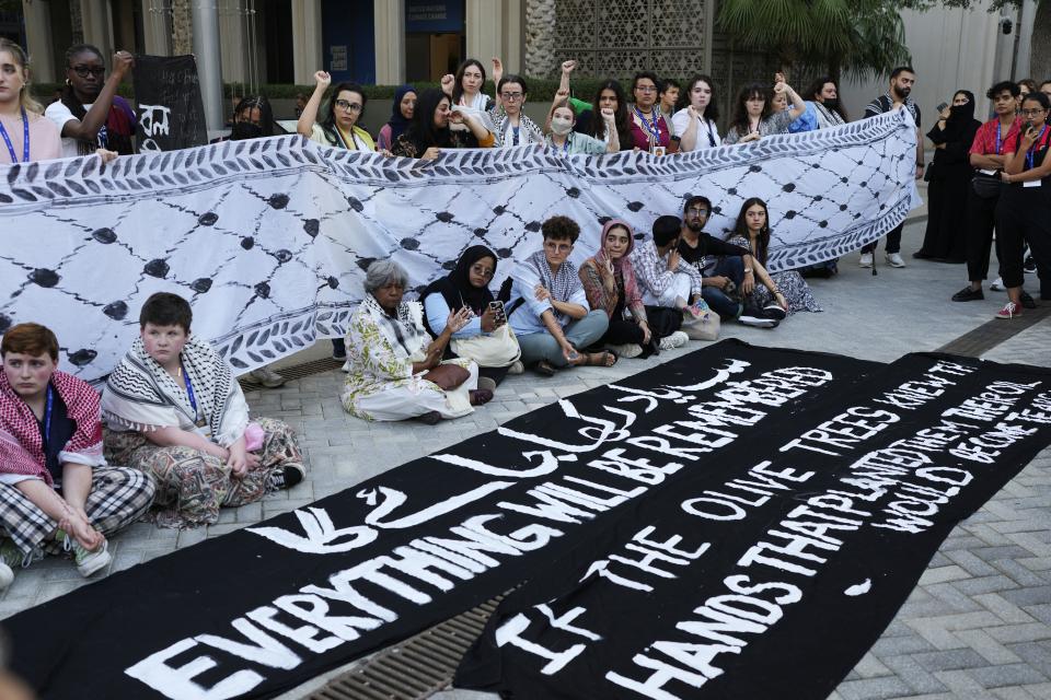 Demonstrators participate in a protest against the Israel-Hamas war during the COP28 U.N. Climate Summit, Wednesday, Dec. 6, 2023, in Dubai, United Arab Emirates. (AP Photo/Rafiq Maqbool)