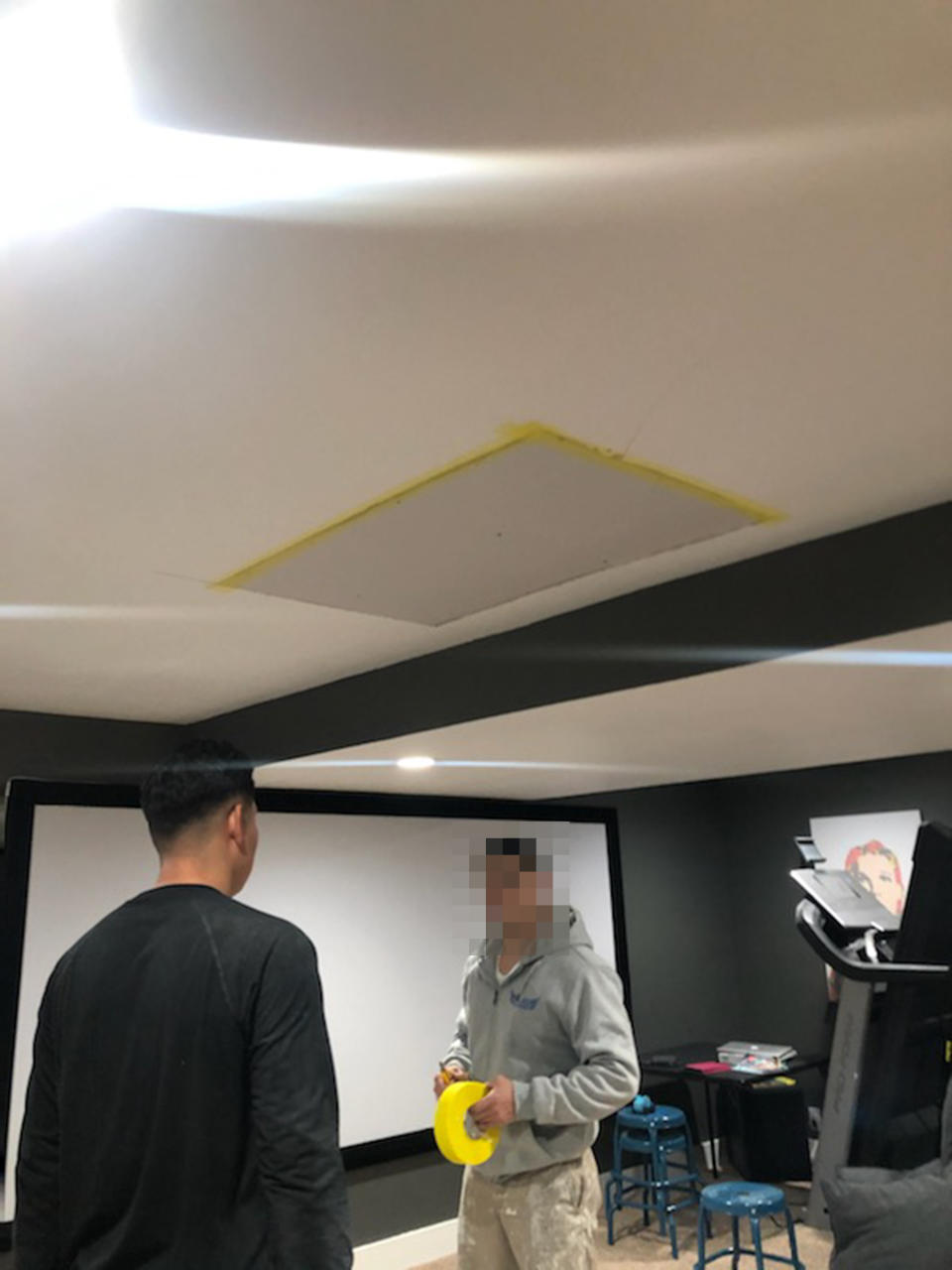 A photo provided by Jeff Hawley shows a hole in the ceiling being patched up after he said a construction worker fell through into the basement. (Teisha Hawley)