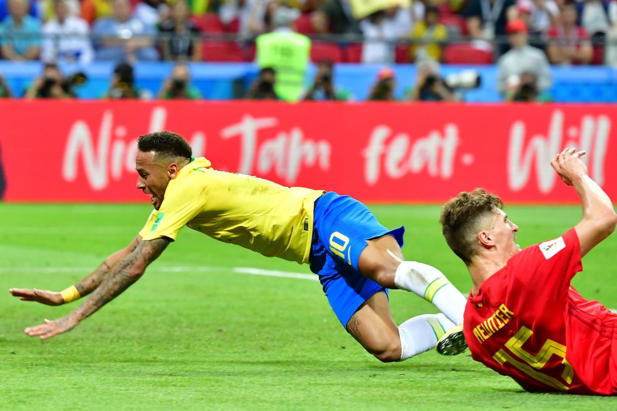 Neymar falls to the ground against Belgium.