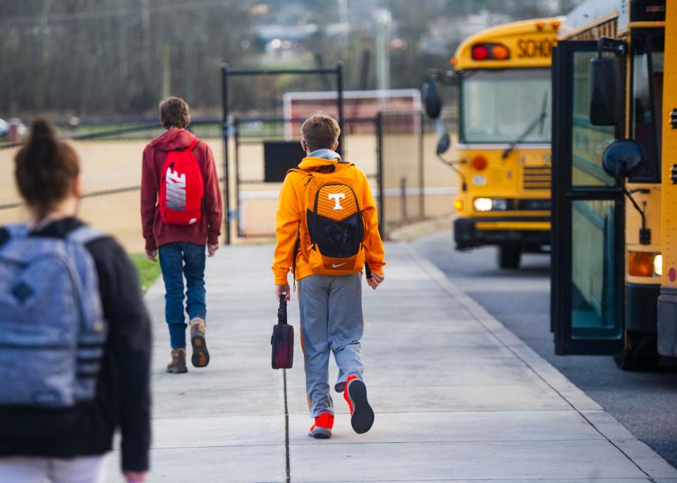 Students head to the buses after the first day of school ends school after the holiday break at Powell Middle in Powell, Tenn., on Tuesday, Jan. 5, 2021. 