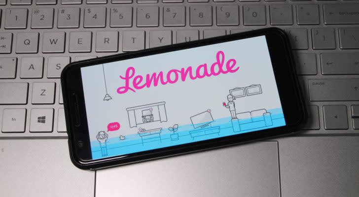 Lemonade logo displayed on smartphone laying on top of computer keyboard.