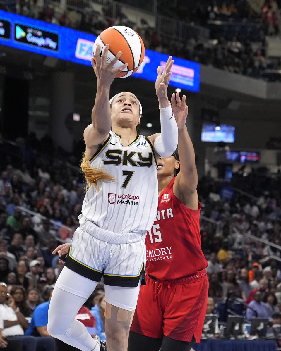 Chicago Sky's Chennedy Carter (7) drives to the basket and scores past Atlanta Dream's Allisha Gray during the second half of a WNBA basketball game Wednesday, July 10, 2024, in Chicago. (AP Photo/Charles Rex Arbogast)