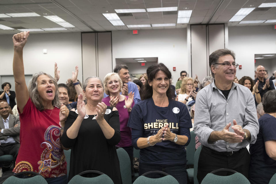 Supporters of Democratic congressional candidate Mikie Sherrill cheer as she arrives for a candidate forum at the UJC of MetroWest New Jersey, Tuesday, Oct. 9, 2018, in Whippany, N.J. (AP Photo/Mary Altaffer)