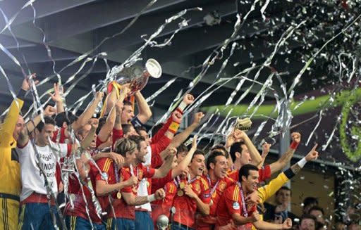 Spanish players celebrate with the trophy after winning the Euro 2012 football championships final match Spain vs Italy at the Olympic Stadium in Kiev. Spain confirmed their status as one of the greatest national teams in football history by overwhelming Italy 4-0 in Sunday's Euro 2012 final in Kiev to retain their European crown