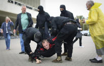 Police detain a man during an opposition rally to protest the official presidential election results in Minsk, Belarus, Sunday, Sept. 27, 2020. Hundreds of thousands of Belarusians have been protesting daily since the Aug. 9 presidential election. (AP Photo/TUT.by)