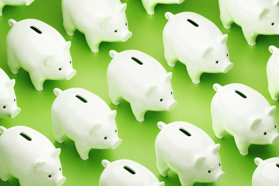 Tiled image of white piggy banks on green background