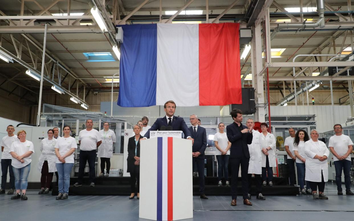 French President Emmanuel Macron visits a factory of automotive manufacturer Valeo in Etaples, France