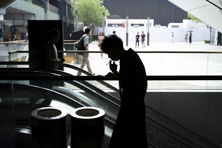 A woman smokes a cigarette in Beijing on June 1, 2015