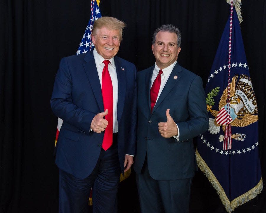 Former President Donald Trump and Florida CFO Jimmy Patronis pose in a photo Patronis tweeted Monday, when he announced a bill that would make $5 million of Florida taxpayers' funds available for Trump's legal defense.