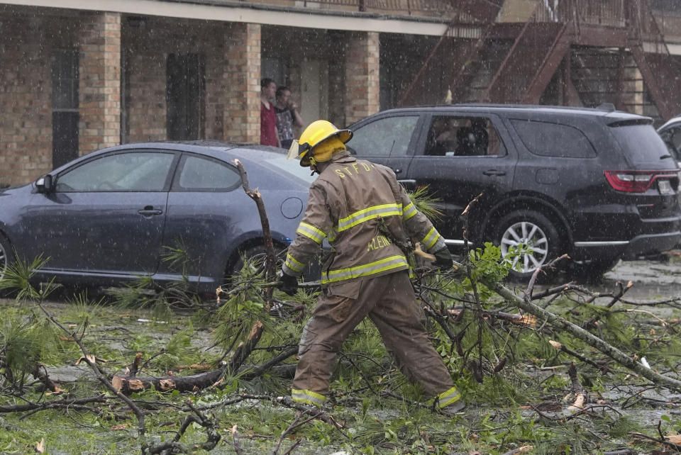 A firefighter clears debris in the aftermath of severe storms that swept through the region in Slidell, La., Wednesday, April 10, 2024. (AP Photo/Gerald Herbert)