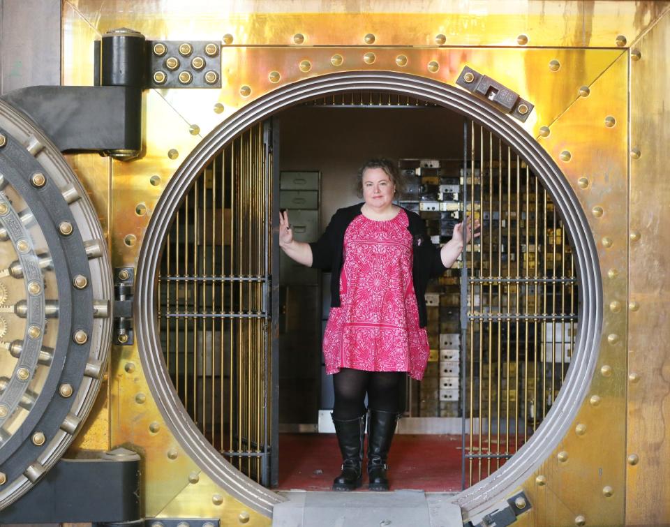 Shannon Okey, founder of Cleveland Bazaar, poses in the vault of the former Second National Bank at The 159 Main building in downtown Akron on March 1. The space will be the new home of Akron Bazaar.