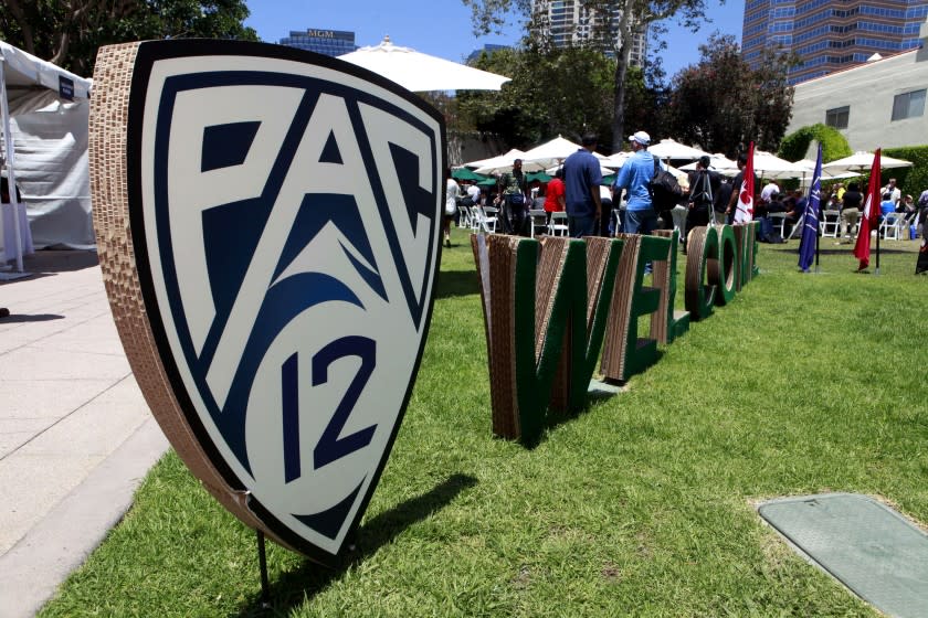 Guests are welcomed to the Pac-12 football media day outside the commissary at Fox Studios in Los Angeles.