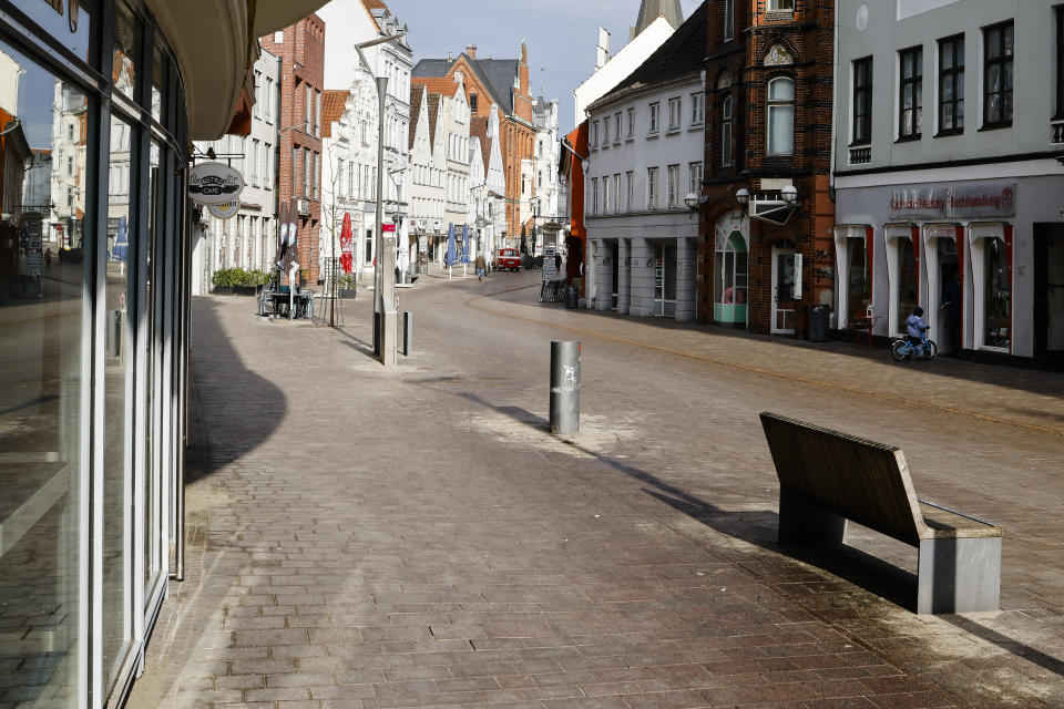 A street is deserted in the city center of Flensburg, Germany, Saturday, Feb. 20, 2021. Because of the high number of coronavirus infections in this northern German area, strickt measures take place in the city to avoid the further spread of the virus, including a curfew during the night from 21.00 in the evening until 5:00 in the morning. (Frank Molter/dpa via AP)