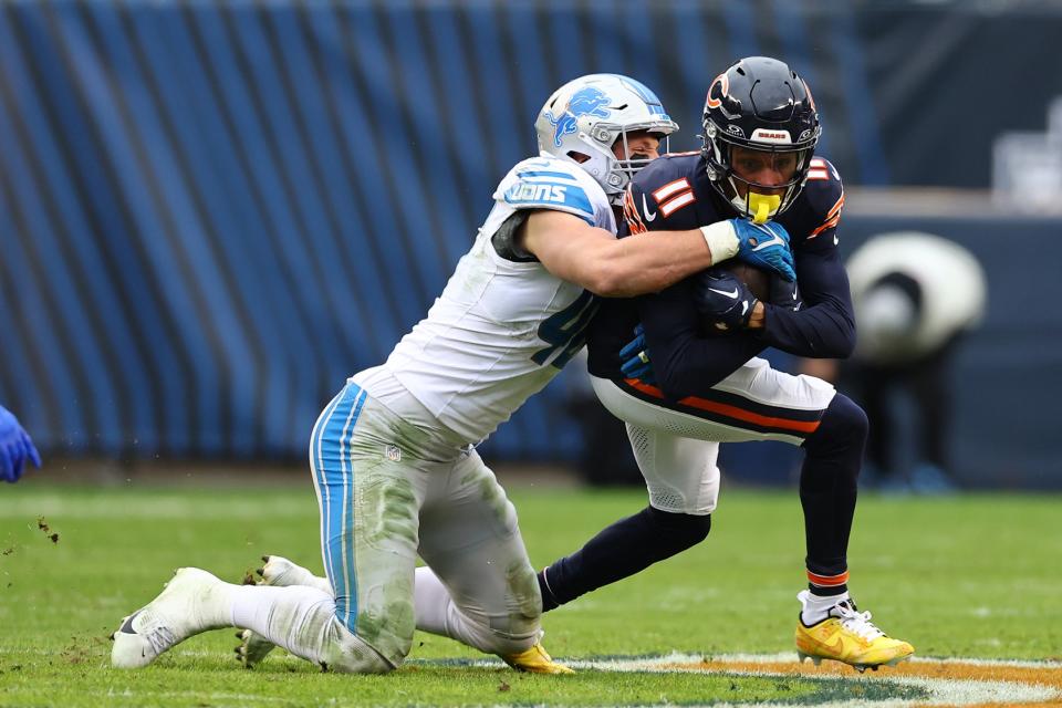 Dec 10, 2023; Chicago, Illinois, USA; Chicago Bears wide receiver Darnell Mooney (11) makes a catch over Detroit Lions linebacker Jack Campbell (46) during the second half at Soldier Field. Mandatory Credit: Mike Dinovo-USA TODAY Sports