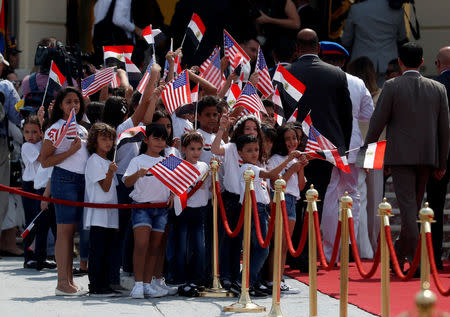 Children look on as U.S. first lady Melania Trump arrives in Cairo, Egypt, October 6, 2018. REUTERS/Carlo Allegri