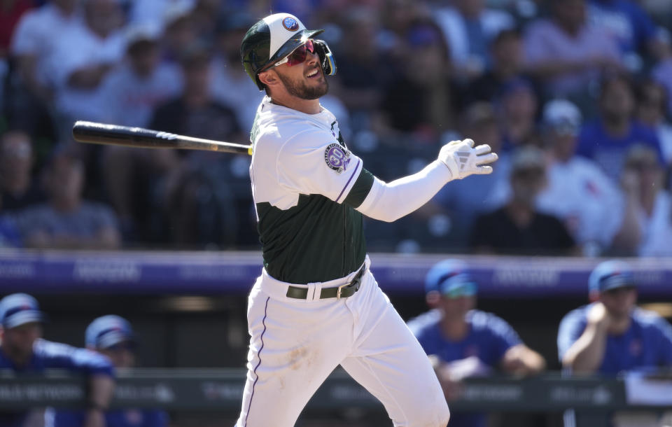 Colorado Rockies' Kris Bryant follows the flight of his solo home run against Chicago Cubs relief pitcher Hayden Wesneski in the seventh inning of a baseball game Wednesday, Sept. 13, 2023, in Denver. (AP Photo/David Zalubowski)