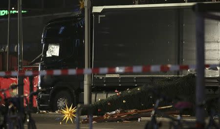A Christmas tree lies next to a truck following an accident with the truck on Breitscheidplatz square near the fashionable Kurfuerstendamm avenue in the west of Berlin, Germany, December 19, 2016. REUTERS/Christian Mang
