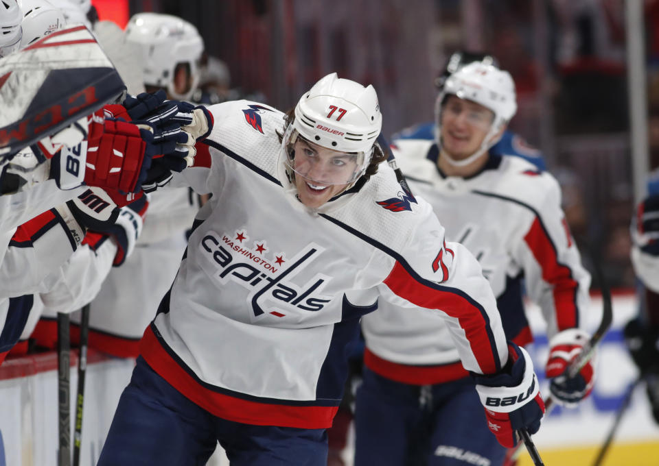 Washington Capitals right wing T.J. Oshie is congratulated as he passes the team box after scoring the go-ahead goal against the Colorado Avalanche during the third period of an NHL hockey game Thursday, Feb. 13, 2020, in Denver. The Capitals won 3-2. (AP Photo/David Zalubowski)
